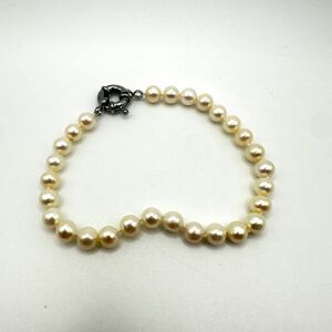 8" freshwater pearl, hand knotted in between with silver tone closed ring clasp!